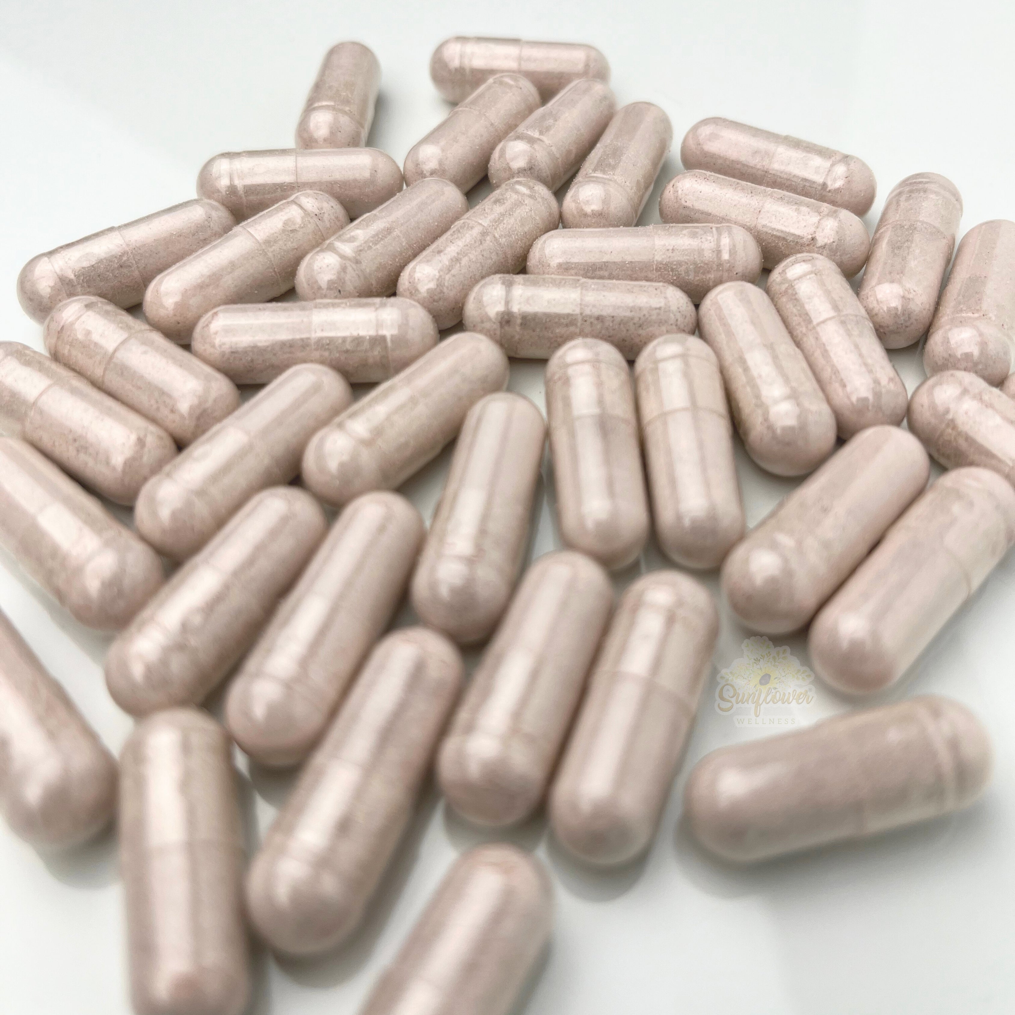 Close-up of vegan sea moss capsules made from full spectrum wildcrafted sea moss – gold, purple, and green blend.